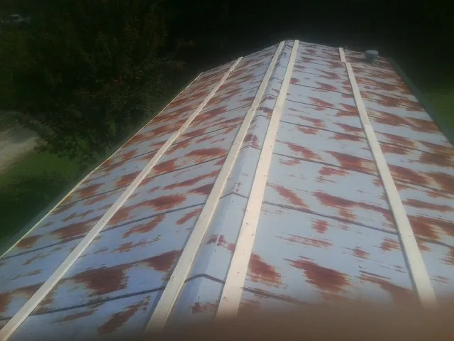 Rusted metal roof panels with new wood purlins before replacement — Storm Damage Roof Repair in Wabasha by Roofing Brothers